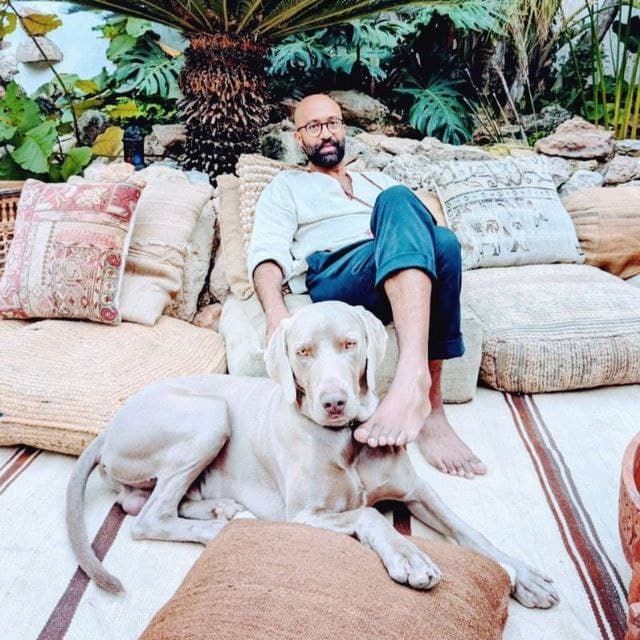 Kaio Moraes Pereira, sitting outdoors with his dog
