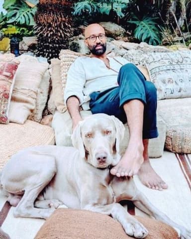 Kaio Moraes Pereira, sitting outdoors with his dog